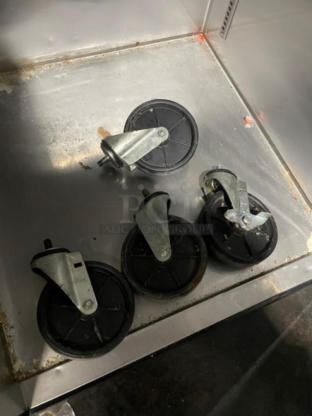 Turbo Air M3F24-1 freezer casters set, featuring four wheels on a stainless steel surface.