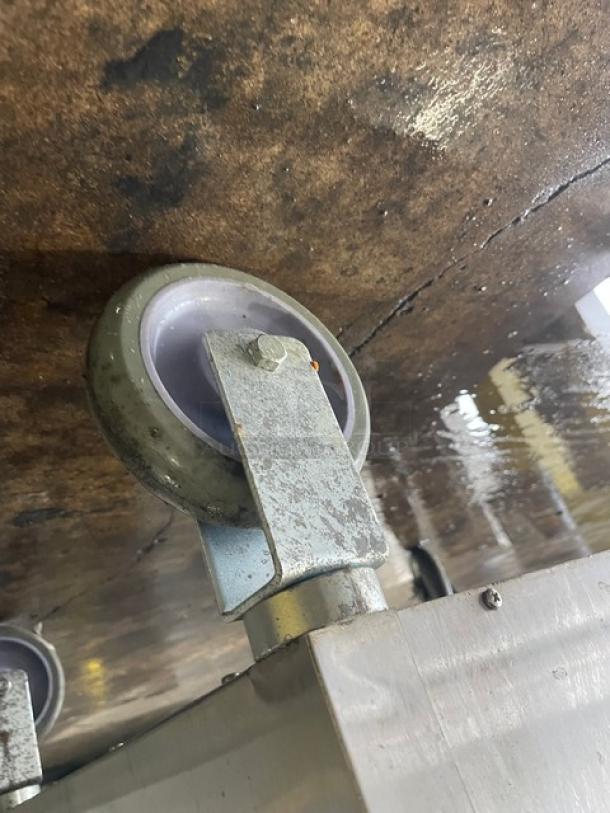 Alto Shaam 1000-UP mobile heated cabinet caster, stainless steel, used, shows wear, part of commercial appliance setup.