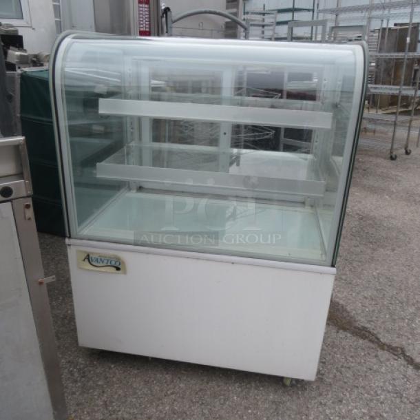 Avantco curved glass dry bakery display case on casters, model 193BCD36W, 36x26.5x48 inches, working condition.