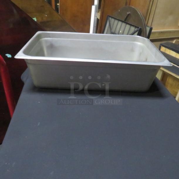 Full size 6-inch deep hotel pan, stainless steel, used condition, visible surface wear, ideal for catering.