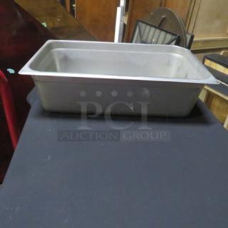 Full size 6-inch deep hotel pan, stainless steel, used condition, visible surface wear, ideal for catering.
