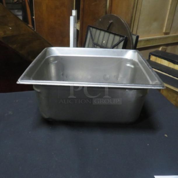 One half-size, 6-inch deep hotel pan, stainless steel, good condition, ideal for catering or food service use.