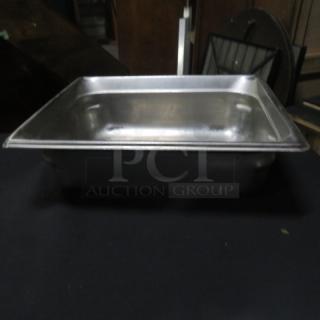 One half-size, 4-inch deep stainless steel hotel pan in good condition, used for food service or storage.