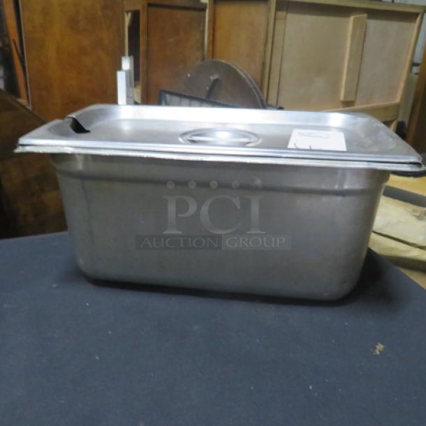 1/3 size, 6-inch deep hotel pan with lid, stainless steel, slightly used, sturdy construction, suitable for commercial use.