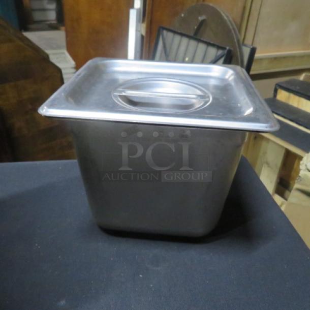 1/6 size 6-inch deep stainless steel hotel pan with lid, shown in good condition. Ideal for commercial kitchen use.