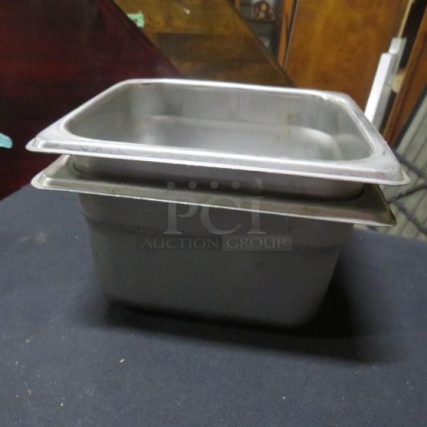 Stainless steel 1/6 size, 4-inch deep hotel pan, used condition, stacked display.