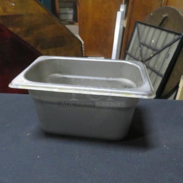 1/9 size 4-inch deep hotel pan, stainless steel, lightly used, ideal for commercial kitchen use.