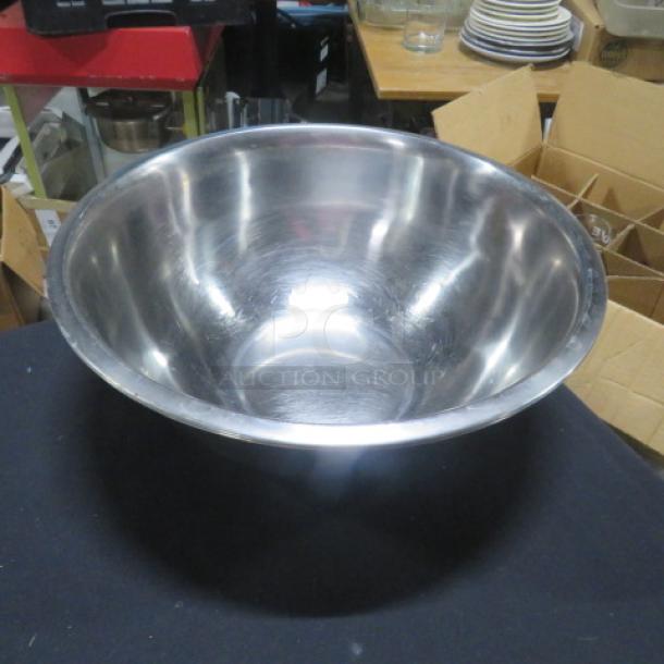 13.5-inch stainless steel mixing bowl, shiny finish, gently used. Ideal for cooking and baking, durable and functional.
