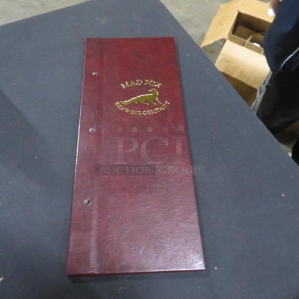NEW Menu Holder, burgundy leatherette, embossed with "MAD FOX Brewing Company" logo, pristine condition.