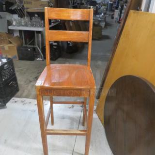 Solid wooden bar height chair with tall back, two horizontal slats. Light oak finish, sturdy condition, minimal wear.