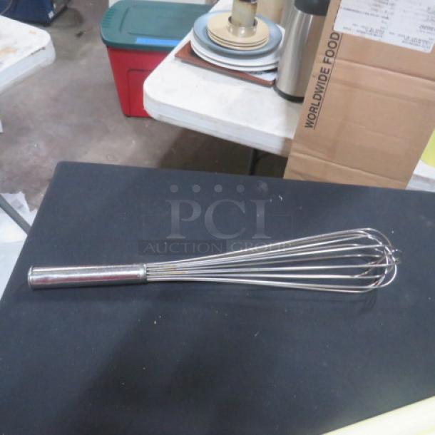 18-inch stainless steel whisk on display, excellent condition, featuring a sturdy handle and evenly spaced wires for effective mixing.
