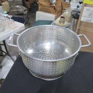 12-inch aluminum colander with handles, used condition. Perforated for draining, ideal for kitchen use.