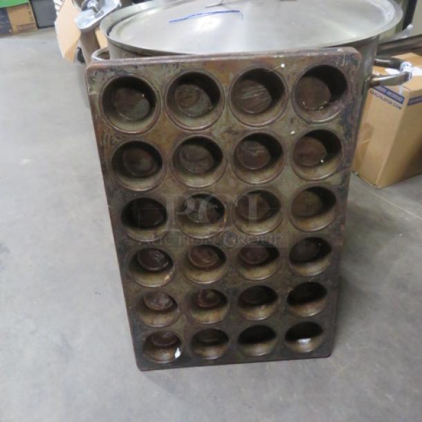 Commercial 24 hole muffin pan, used. Durable metal construction, suitable for high-volume baking. Some wear visible.