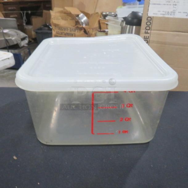 Clear 4-quart food storage container with lid, red measurement markings on side, good condition.