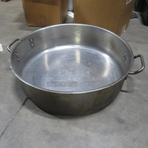 Aluminum braising pan, 20x6 inches, with dual handles, in used condition. No visible markings or tags.