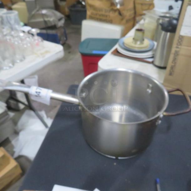 Stainless steel saucepan, 8x6 inches, used condition, with handle and spout. Suitable for cooking sauces or boiling.