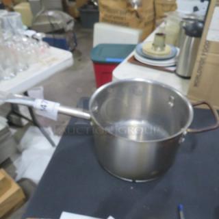 Stainless steel saucepan, 8x6 inches, used condition, with handle and spout. Suitable for cooking sauces or boiling.