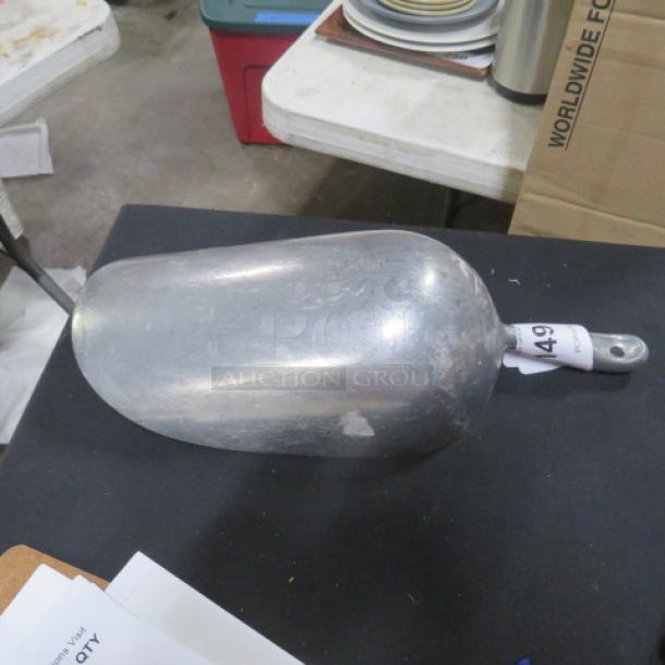 85oz aluminum scoop with handle, used condition, showing light wear. Numbered tag on handle marked "49."