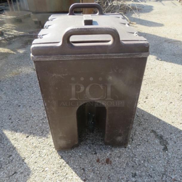 Cambro 1000LCD insulated beverage dispenser, brown, sturdy handles, used condition, outdoor use, markings on the front.
