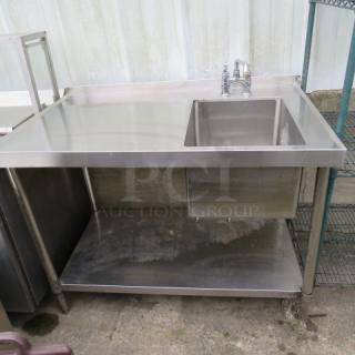 Stainless steel table with under shelf, sink, faucet, and backsplash, measuring 48x30x48 inches. Good condition.