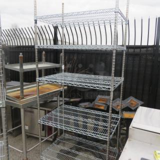 Metro shelf unit with 5 wire shelves, dimensions 36"x18"x87". Sturdy metal construction, suitable for storage.