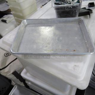 Half size aluminum sheet pan with minor surface wear, suitable for baking and roasting. No visible labels or markings.
