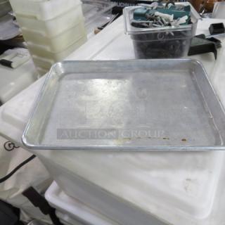 Half size sheet pan, metal, used condition. Sturdy, shallow, rectangular with raised edges. Ideal for baking and roasting.
