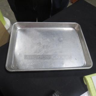 1/4 Size Sheet Pan, used condition, metallic finish, slight surface scratches, suitable for baking or roasting.