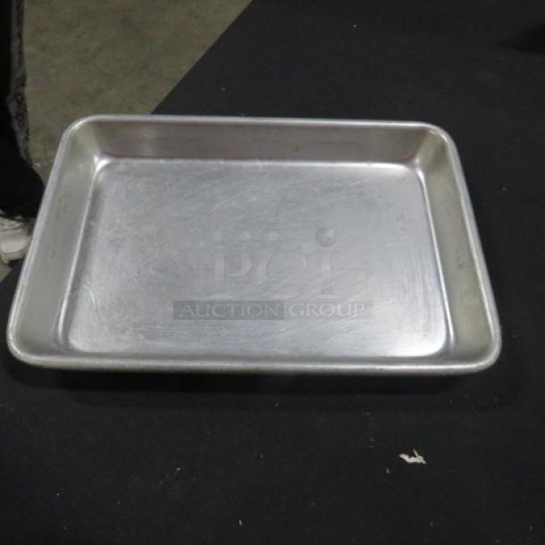 9.5x7 aluminum sheet pan, gently used, showing minor surface scratches.