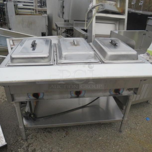 APW WYOTT 3 Well Electric Steam Table with cutting board and stainless steel under shelf, size 46x30x34, in used condition.