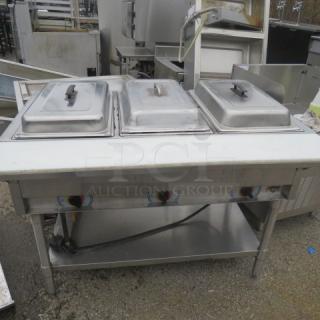 APW WYOTT 3 Well Electric Steam Table with cutting board and stainless steel under shelf, size 46x30x34, in used condition.