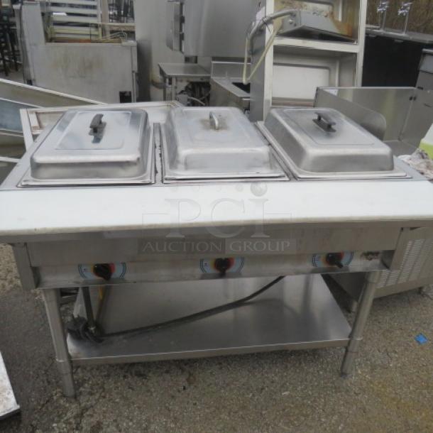 APW WYOTT 3 Well Electric Steam Table with cutting board and stainless steel under shelf, dimensions 46x30x34 inches.