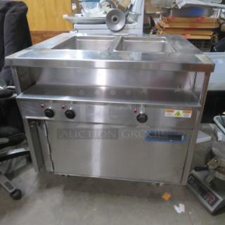 Randell 2 Well 1 Door Warmer on Casters, Model 31330, 208V, stainless steel, 36x33x34 inches, 3 control knobs, label indicates voltage.