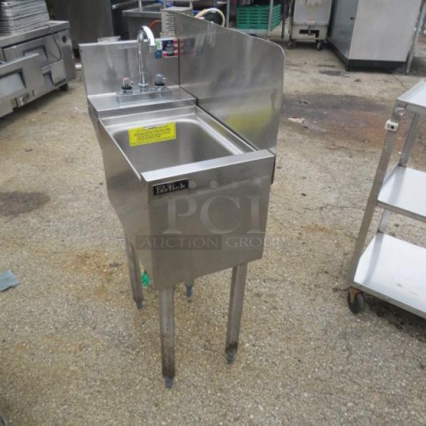 Perlick under bar hand sink with faucet, backsplash, and right side splash, 12x24x35.5 inches. Stainless steel, labeled.