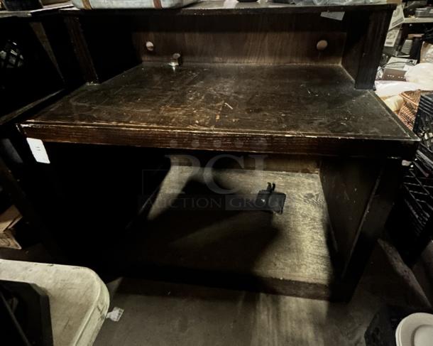 Wooden hostess stand with under storage, dimensions 48x33x47 inches. Dark finish, signs of wear, ideal for restaurant use.