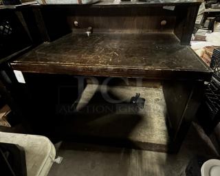 Wooden hostess stand with under storage, dimensions 48x33x47 inches. Dark finish, signs of wear, ideal for restaurant use.