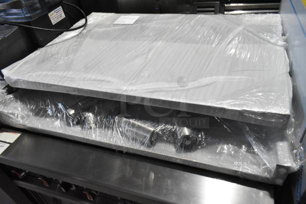Stainless steel commercial range w/ oven, model RC-ENR6B36TJ-NAT, 2024, new, covered in protective wrap with tags.