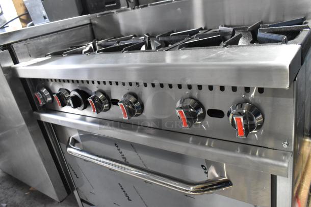Brand new 2024 stainless steel 6-burner range with oven. Model RC-ENR6B36TJ-NAT, 210,000 BTU. Tags indicate "Nitto".