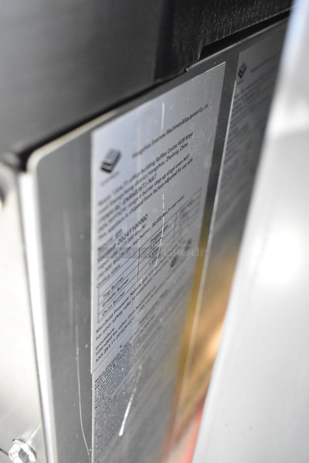 Close-up of a brand-new RC-ENR6B36TJ-NAT stainless steel commercial range. Visible label details model and specs.