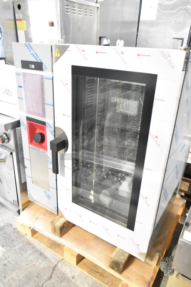 Bakers Pride stainless steel commercial combi convection oven, new with minor scratches, shown on a pallet.