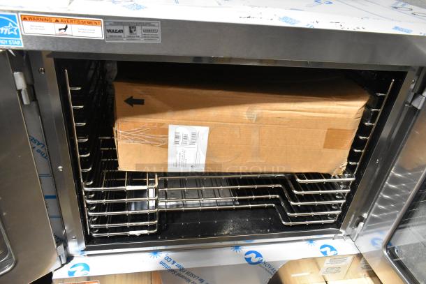 Brand new Vulcan VC5ED stainless steel convection oven with view-through doors, metal racks, and thermostatic controls.