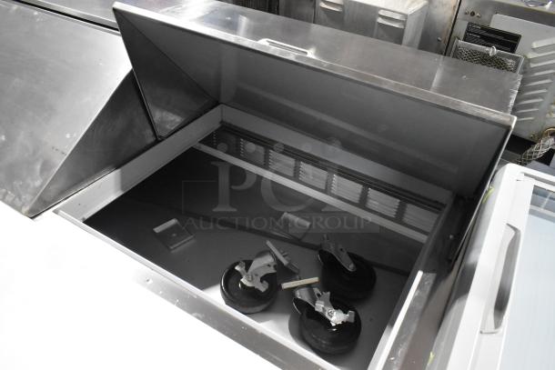 Beverage Air SPE72HC-30M stainless steel refrigerated sandwich prep table, new with minor scratches. Includes wheels, 72-inch, 115V.