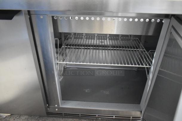 Brand new Beverage Air SPE72HC-30M 72" stainless steel 3-door refrigerated prep table, scratch and dent, open view.