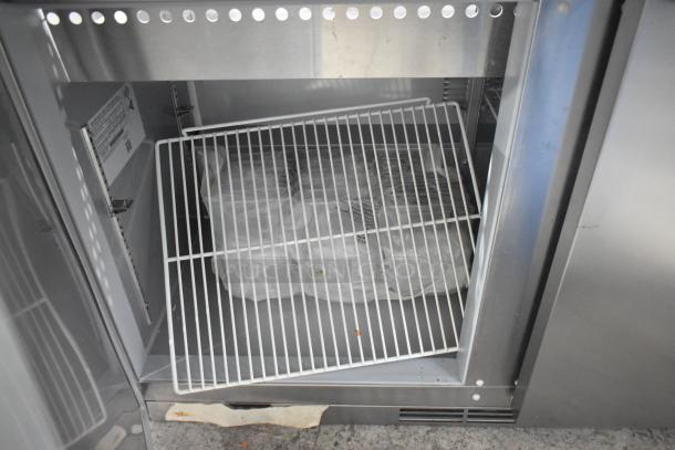 Brand new Beverage Air SPE72HC-30M 72" stainless steel 3-door refrigerated prep table, interior view with wiring shown.