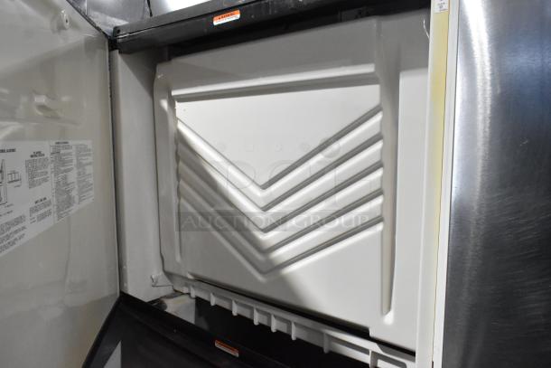 Manitowoc SD1802A stainless steel commercial ice head on bin, 208-230V, 1 phase, clean interior, visible warning label.