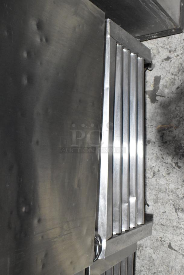 True T-23F stainless steel commercial freezer with poly-coated rack, scratches and dents, on casters. Model T-23F.