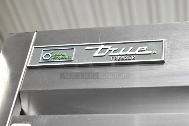 Stainless steel True T-23F-HC commercial freezer, single door, poly-coated rack, on casters. Features logo and natural refrigerant label.