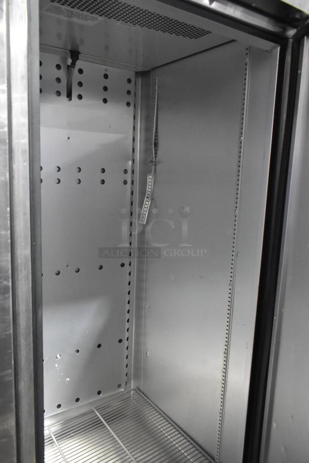 2018 True T-23F-HC stainless steel commercial single door reach-in freezer interior, poly coated rack, on casters.