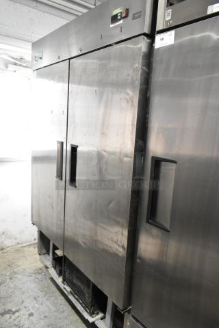Avantco 178A49FHC stainless steel 2-door commercial freezer on casters, includes poly-coated rack, 115V, 1 phase. Signs of use visible.