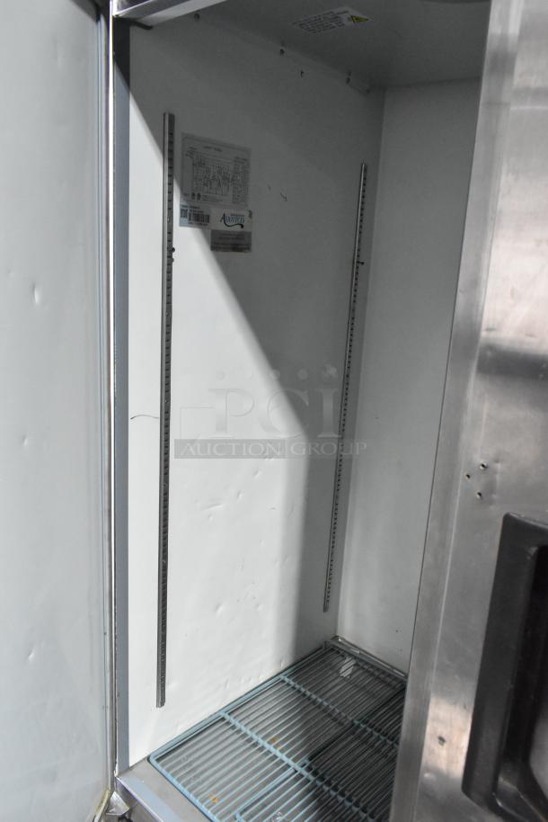 Avantco 178A49FHC stainless steel commercial freezer interior, showing poly coated rack, shelf tracks, and visible label.